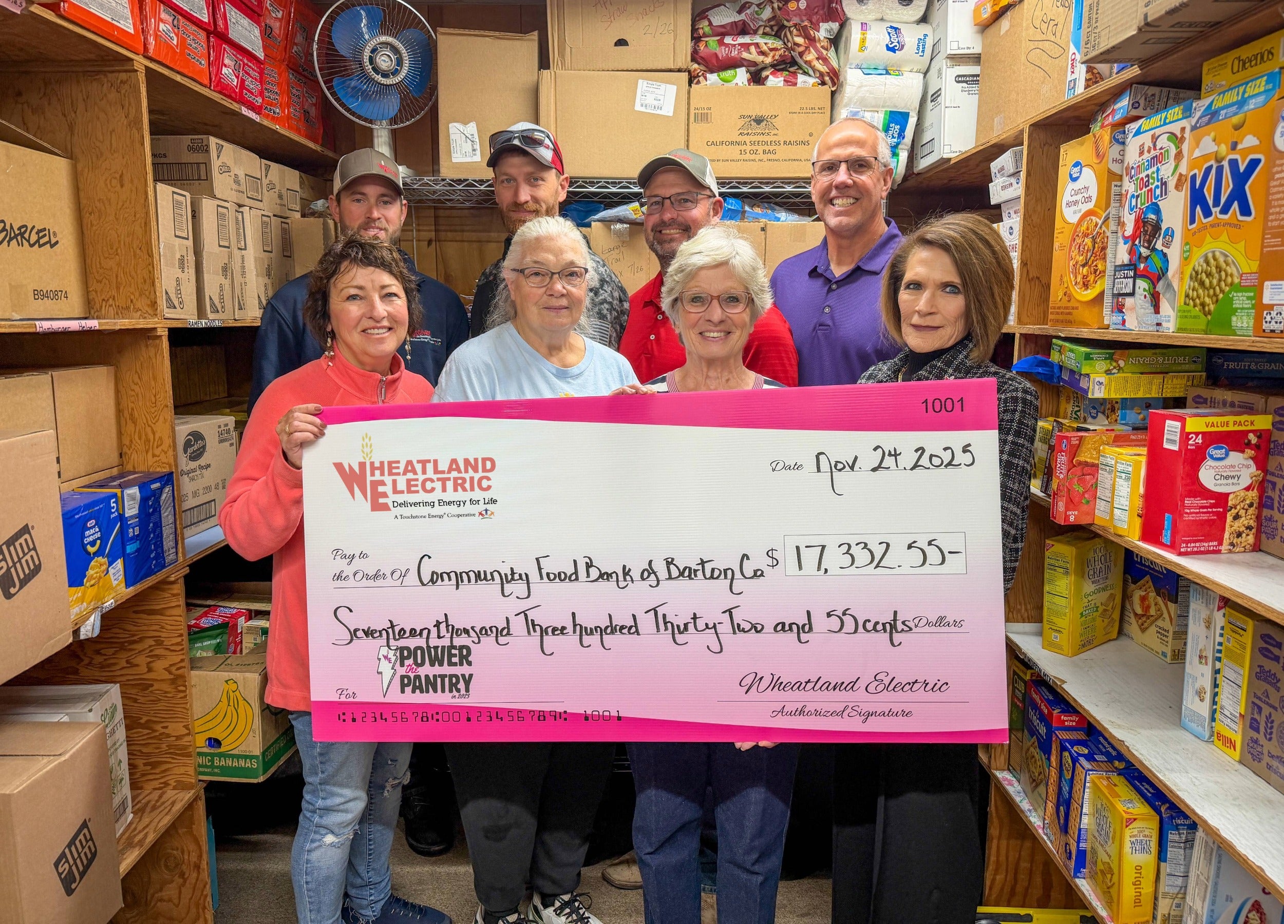 Alli Conine (right), director of member services and corporate communications at Wheatland Electric, and Josh Young, trustee (left), present a check for $7,055 to Mirna Jimenez (center) of the Wichita County Food Bank. 
