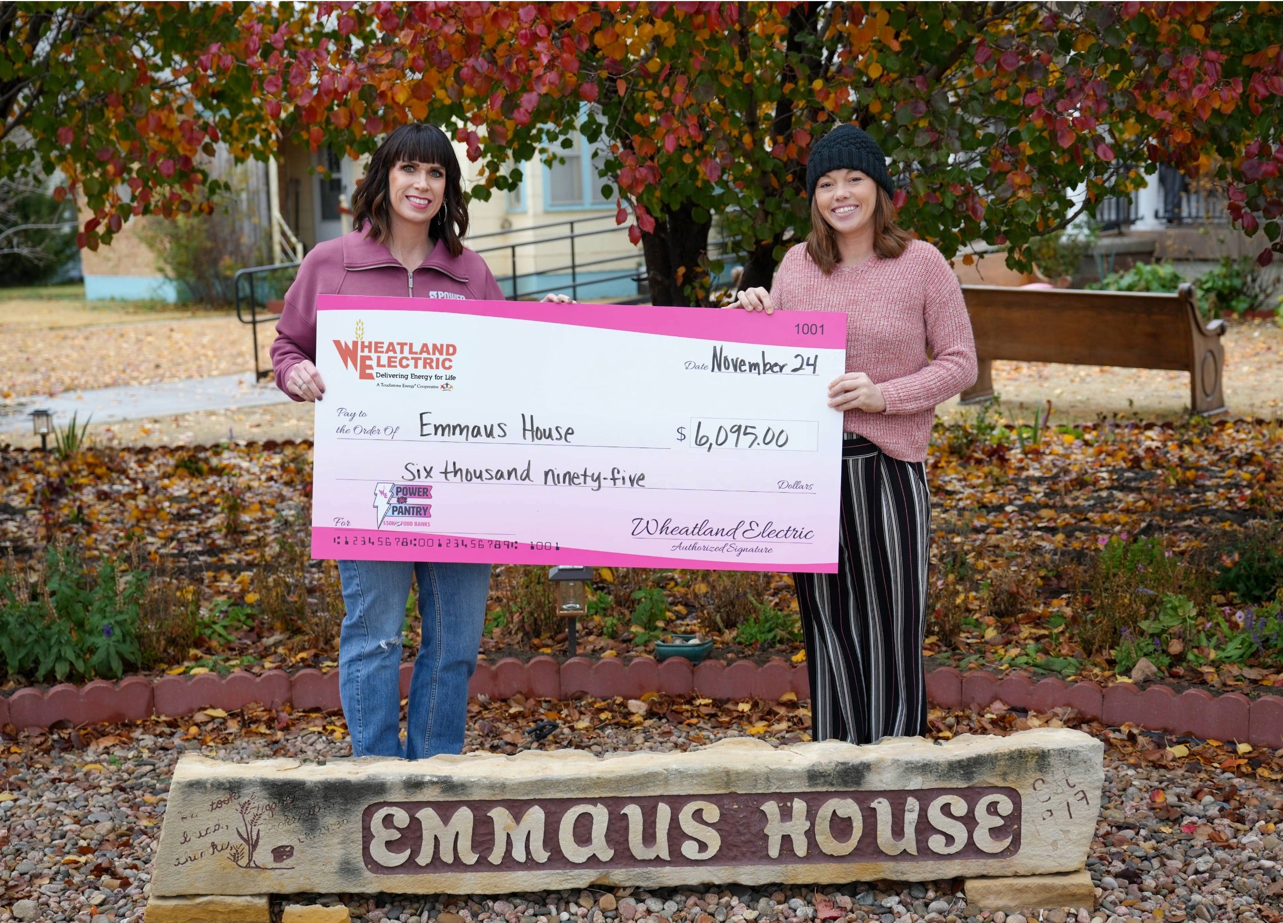 Alli Conine (right), director of member services and corporate communications at Wheatland Electric, presents a check for $6,095 to Brittney Knoll, director of the Emmaus House.