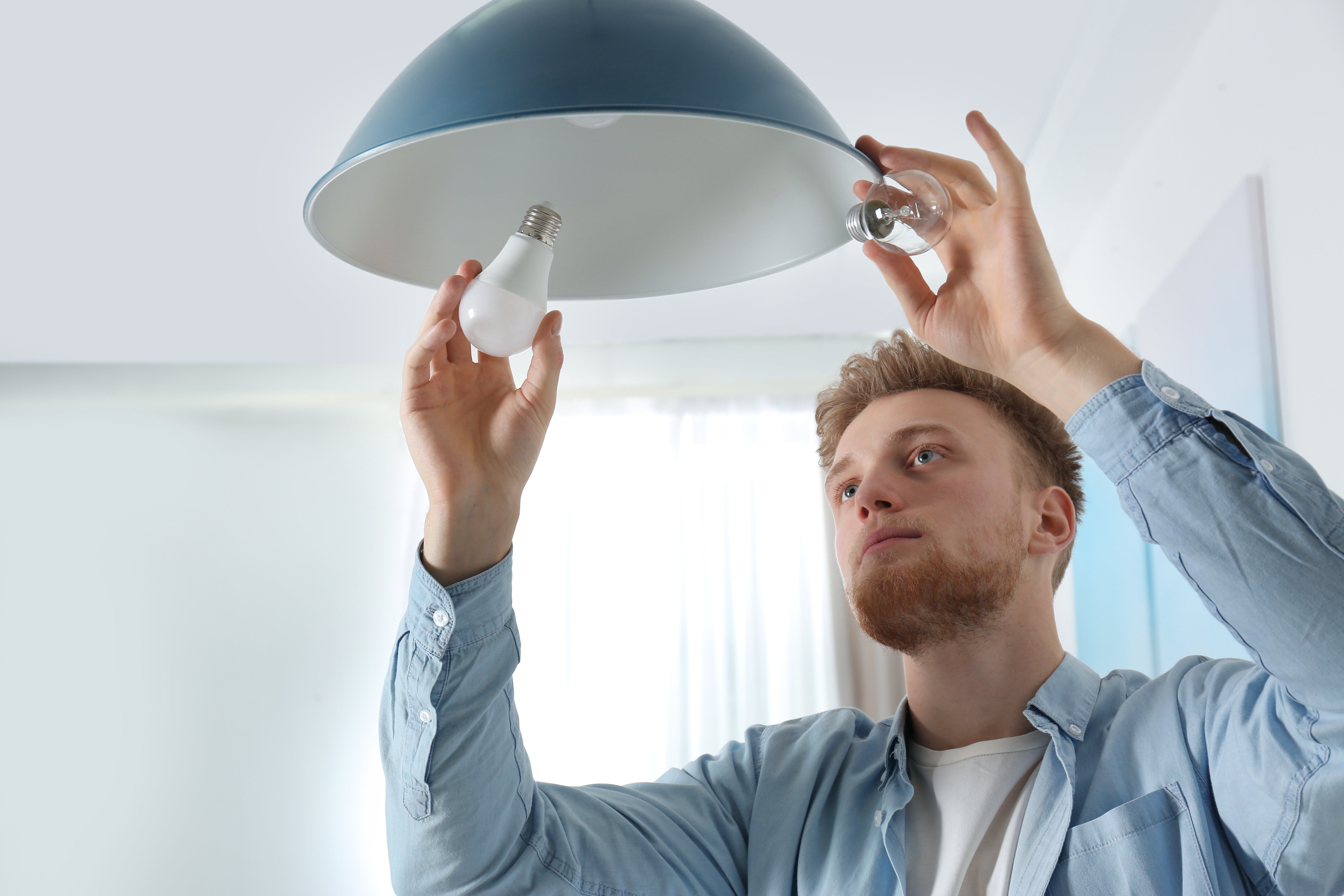 Man changing light bulb