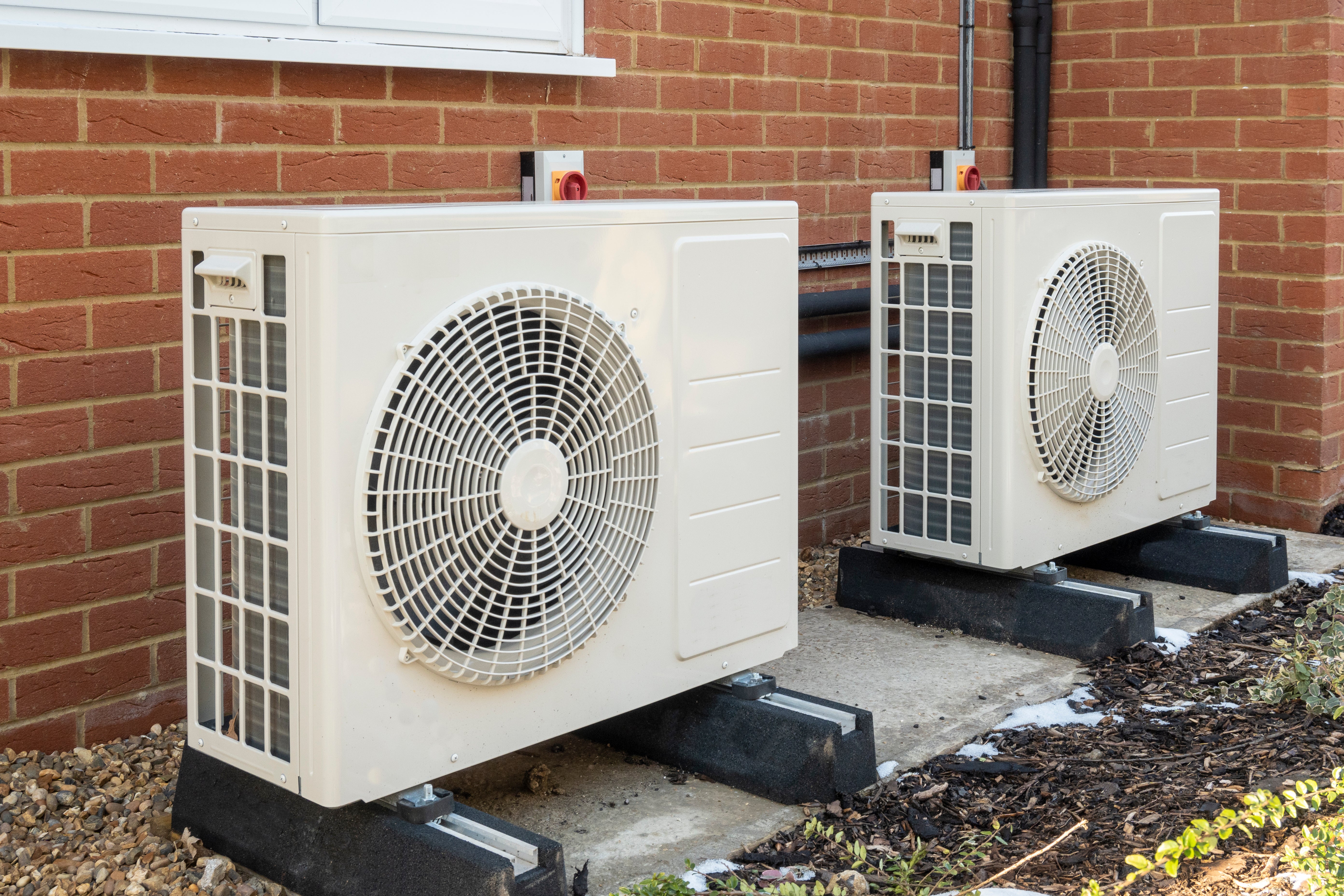 Heat pumps outside modern home