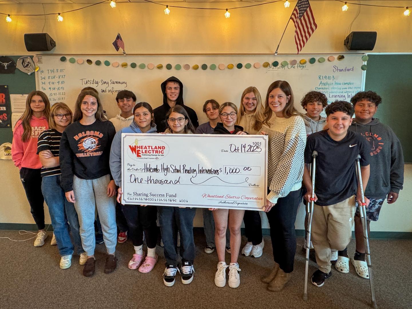 Holcomb High School Reading Interventions instructor, Rachel Davis (second from right) and students receive a $1,000 Wheatland Electric Sharing Success grant to help purchase new materials for the reading intervention program.