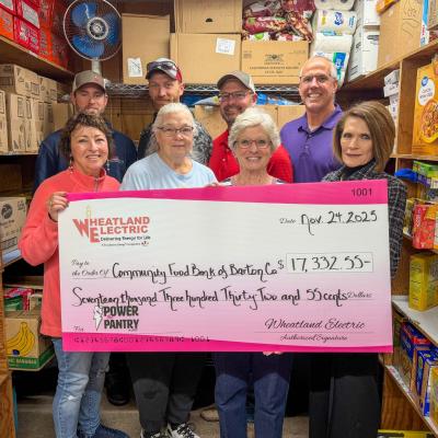 Representatives of Wheatland Electric (backrow, left to right) Kreyton Demel and Chris Oliver, line foremen, Dax Walk, district manager, John Sullivan, trustee, and Maribeth Benker, trustee (pictured in the front row, far right), present a check for $17,332 to the Community Food Bank of Barton County volunteers. Pictured in the front row (left to right) are Marsha Gillenwater, Kathy Levingston, and Ruth Behrens, representatives of the food pantry. 