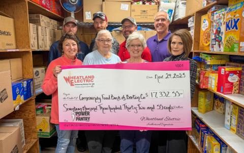 Representatives of Wheatland Electric (backrow, left to right) Kreyton Demel and Chris Oliver, line foremen, Dax Walk, district manager, John Sullivan, trustee, and Maribeth Benker, trustee (pictured in the front row, far right), present a check for $17,332 to the Community Food Bank of Barton County volunteers. Pictured in the front row (left to right) are Marsha Gillenwater, Kathy Levingston, and Ruth Behrens, representatives of the food pantry. 